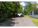 Gravel driveway with a covered parking area near the home, offering convenience and functionality at 21785 Lowcountry Hwy, Ruffin, SC 29475
