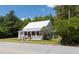 Charming white two-story home with inviting front porch, and mature landscaping at 21785 Lowcountry Hwy, Ruffin, SC 29475
