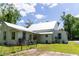 Rear of a two-story home featuring a metal roof, classic siding, and a spacious yard at 21785 Lowcountry Hwy, Ruffin, SC 29475