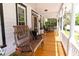 Relaxing front porch with a charming swing, wooden floor, and views of the surrounding landscape, perfect for unwinding at 21785 Lowcountry Hwy, Ruffin, SC 29475