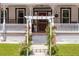 Inviting front porch with decorative pergola, classic railings, and well-maintained landscaping, steps to front door at 21785 Lowcountry Hwy, Ruffin, SC 29475