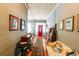 Inviting hallway with wood floors and walls leading to a vibrant red door at 21785 Lowcountry Hwy, Ruffin, SC 29475