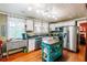 Bright kitchen with island, stainless steel appliances, black countertop and colorful curtains at 21785 Lowcountry Hwy, Ruffin, SC 29475