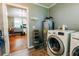 Well-lit laundry room features a washer, dryer, and convenient access to the kitchen at 21785 Lowcountry Hwy, Ruffin, SC 29475