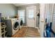Laundry room with gray walls, washer, dryer, and a door to the outside at 21785 Lowcountry Hwy, Ruffin, SC 29475
