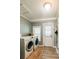 Bright laundry room with washer, dryer, wooden floors, and direct access to the outdoors at 21785 Lowcountry Hwy, Ruffin, SC 29475