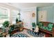 Bright and cozy living room with house plants, a comfortable seating area, and a decorative rug at 21785 Lowcountry Hwy, Ruffin, SC 29475