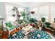 Bright living room features many plants, large windows, comfortable seating, and nice decor at 21785 Lowcountry Hwy, Ruffin, SC 29475