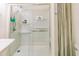 All-white shower enclosure featuring glass doors, tiled walls, and modern fixtures at 21785 Lowcountry Hwy, Ruffin, SC 29475
