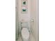 Neat toilet with nautical-themed art and decor in a simple, bright space at 21785 Lowcountry Hwy, Ruffin, SC 29475