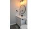 This powder room features a modern black faucet and a unique round mirror at 227 Amy Dr, Goose Creek, SC 29445