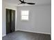 An airy bedroom features black folding closet doors, a window and modern ceiling fan at 227 Amy Dr, Goose Creek, SC 29445