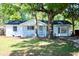 Charming white brick home featuring mature trees, a cozy front porch, and a freshly painted exterior at 227 Amy Dr, Goose Creek, SC 29445