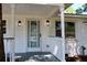 Inviting front porch with decorative railing, modern sconces, and a glass-paneled door, perfect for welcoming guests at 227 Amy Dr, Goose Creek, SC 29445