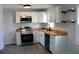 Updated kitchen features white cabinetry, sleek stainless steel appliances, and butcher block countertops for a contemporary look at 227 Amy Dr, Goose Creek, SC 29445