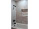 The tiled shower features updated fixtures, a modern shower head, and a recessed shelf at 227 Amy Dr, Goose Creek, SC 29445