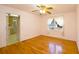 Bedroom featuring hardwood floors, a ceiling fan, and a large window at 2300 Bethera Rd # B, Bonneau, SC 29431