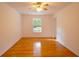 An empty bedroom featuring hardwood flooring, neutral walls, a ceiling fan, and a large window at 2300 Bethera Rd # B, Bonneau, SC 29431