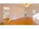 Bedroom featuring hardwood floors and access to both bathroom and a door leading outside at 2300 Bethera Rd # B, Bonneau, SC 29431