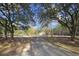 A long driveway leads to a charming home surrounded by lush trees at 2300 Bethera Rd # B, Bonneau, SC 29431