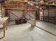 Large, unfinished garage with exposed beams and lawn equipment at 2300 Bethera Rd # B, Bonneau, SC 29431