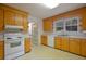 The kitchen features light wood cabinets and white appliances, providing a functional space for cooking at 2300 Bethera Rd # B, Bonneau, SC 29431