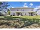 Expansive backyard featuring a lawn with mature trees providing shade and dual screened in porches at 254 Cypress Marsh Rd, Moncks Corner, SC 29461