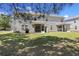 Expansive backyard featuring a lawn with mature trees providing shade and dual screened in porches at 254 Cypress Marsh Rd, Moncks Corner, SC 29461