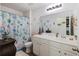 Bright bathroom with double vanity, large mirror, and floral shower curtain at 254 Cypress Marsh Rd, Moncks Corner, SC 29461