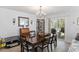 Charming dining area featuring a chandelier, a wooden dining table, and sliding glass doors to the patio at 254 Cypress Marsh Rd, Moncks Corner, SC 29461