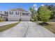 A two-story exterior view featuring a wide driveway, two-car garage, neutral colors, and manicured landscaping at 254 Cypress Marsh Rd, Moncks Corner, SC 29461