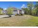 Charming two-story home with a two car garage, manicured landscaping, and a private wooded backyard at 254 Cypress Marsh Rd, Moncks Corner, SC 29461