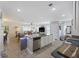 Bright open kitchen featuring a granite island, stainless steel dishwasher, and a view into the living room at 254 Cypress Marsh Rd, Moncks Corner, SC 29461