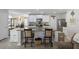 Bright kitchen featuring an island with barstool seating, granite countertops, and stainless steel appliances at 254 Cypress Marsh Rd, Moncks Corner, SC 29461
