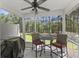 Comfortable screened patio with ceiling fan, table, chairs, and private backyard view at 254 Cypress Marsh Rd, Moncks Corner, SC 29461