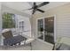 Relaxing screened patio with a ceiling fan, seating, and a beautiful view of the backyard at 254 Cypress Marsh Rd, Moncks Corner, SC 29461