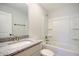 Bright bathroom showcasing a granite countertop vanity and shower with white tiled walls at 2606 Bennett Yard Rd, North Charleston, SC 29405