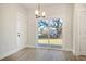Bright dining area features a sliding glass door to the backyard and modern light fixture at 2606 Bennett Yard Rd, North Charleston, SC 29405