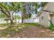 A backyard with green grass, mature trees, and white fence at 2919 Fernwood Dr, North Charleston, SC 29406
