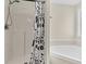 This well-lit bathroom has a tub and shower with a black and white shower curtain, and a separate bathtub at 2919 Fernwood Dr, North Charleston, SC 29406