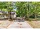 Long driveway leading to the house and detached garage, surrounded by mature trees at 2919 Fernwood Dr, North Charleston, SC 29406