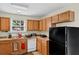 Bright kitchen featuring oak cabinets, modern appliances, a double basin sink, and a window that allows natural light at 2919 Fernwood Dr, North Charleston, SC 29406