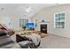 Bright living room with a fireplace, television, and large windows for natural light at 2919 Fernwood Dr, North Charleston, SC 29406