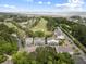 Aerial shot features community nestled among trees, overlooking a golf course and a serene body of water at 3019 Fraserburgh Way, Mount Pleasant, SC 29466