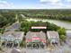 Aerial view of townhouses nestled near a scenic lake and lush green forest at 3019 Fraserburgh Way, Mount Pleasant, SC 29466