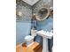 Stylish powder room with blue walls, decorative wallpaper, and a pedestal sink at 3019 Fraserburgh Way, Mount Pleasant, SC 29466