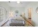 Cozy bedroom features a floral-patterned bedspread, decorative mirror, and ensuite bathroom access at 3019 Fraserburgh Way, Mount Pleasant, SC 29466