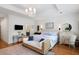 Bright bedroom features a chandelier, TV, stylish furniture, and ensuite bathroom at 3019 Fraserburgh Way, Mount Pleasant, SC 29466