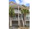 Inviting townhome featuring double porches, stairs to the main entrance, and a two-car garage at 3019 Fraserburgh Way, Mount Pleasant, SC 29466