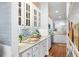 Kitchen area featuring white cabinets with display shelves and stainless steel appliances at 3019 Fraserburgh Way, Mount Pleasant, SC 29466